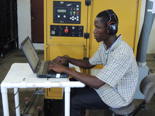 Generator-1 Haitian staff trained to monitor generators for efficient use.